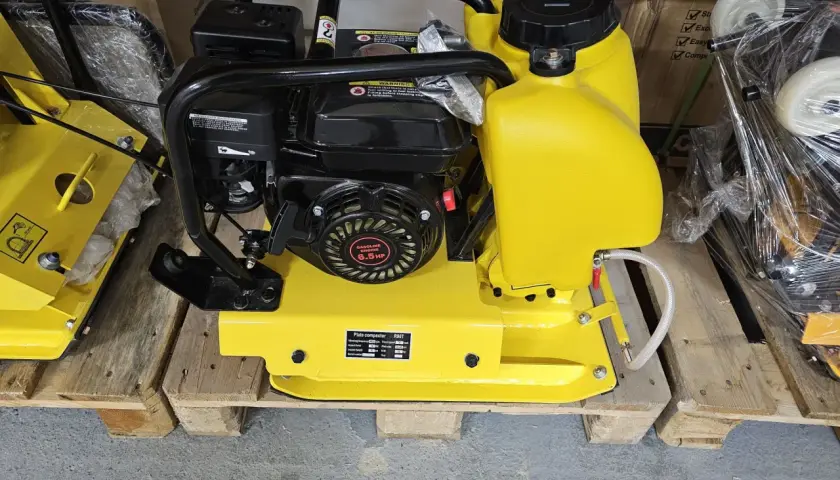 Żółta zagęszczarka płytowa z silnikiem 6.5 HP. Czy na zagęszczarkę potrzebne są uprawnienia? Zwykle nie, ale warto sprawdzić lokalne przepisy.